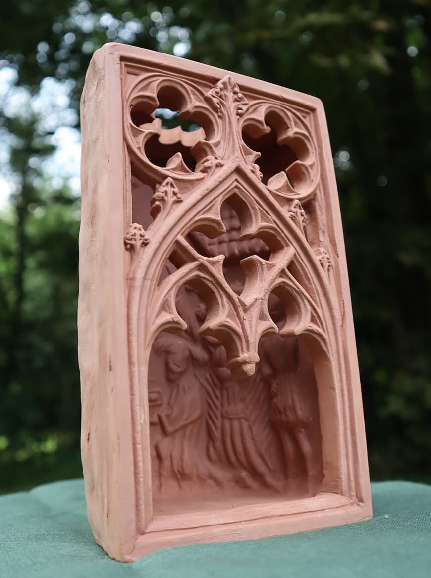 Reconstructed Gothic stove tile in terracotta, with an arched tracery frame and a figural scene